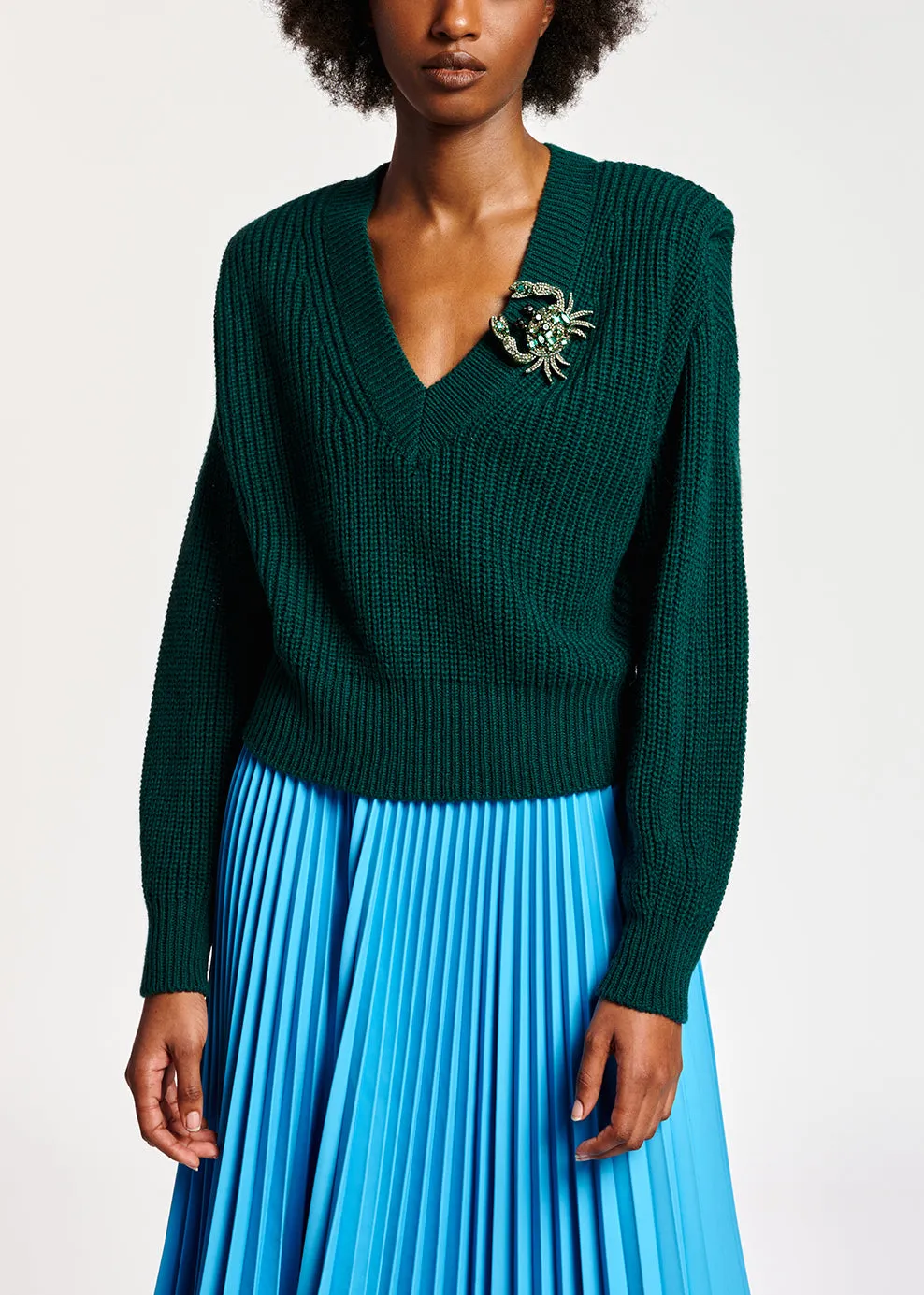 Dark green sweater with padded shoulders