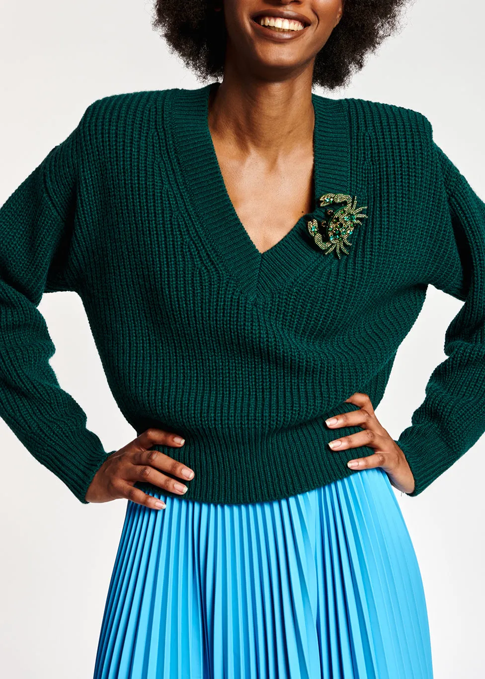 Dark green sweater with padded shoulders